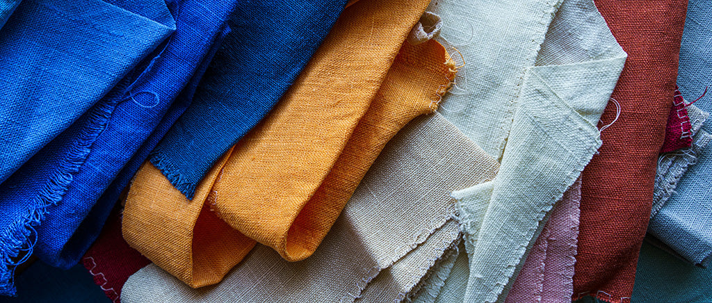 Colorful natural linen fabric samples in different textures and shades for sustainable fashion and clothing design