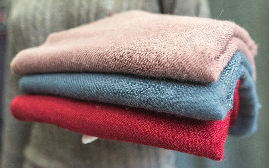 Folded Pashmina shawls showcasing luxurious wool texture