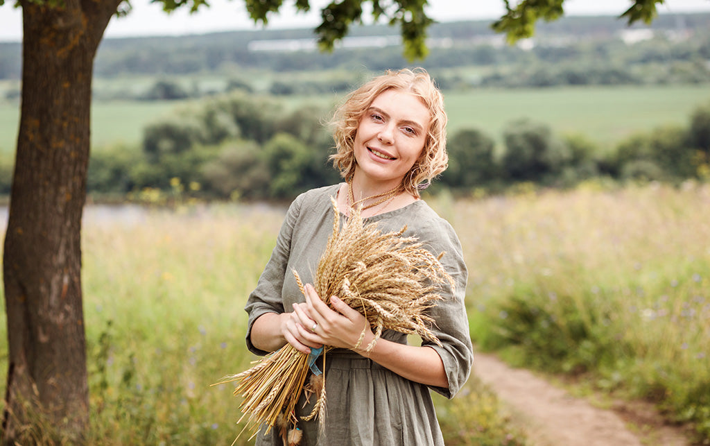 Smiling woman wearing linen outfit standing in nature field