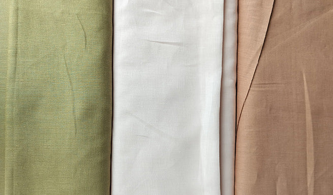 Soft linen fabric in green, white, and light brown colors