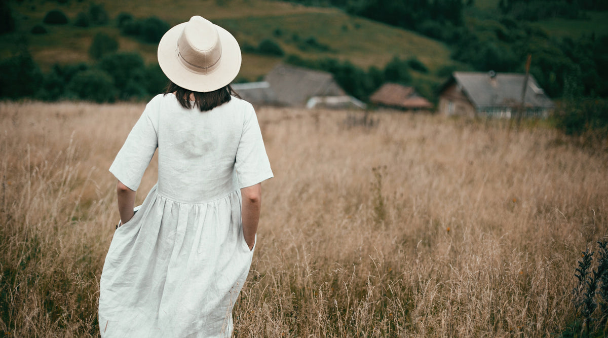 young women in linen dress in the field