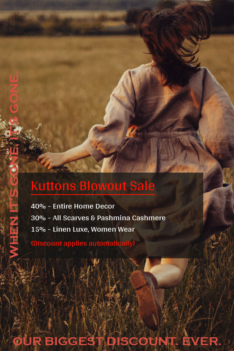 Woman running through a field with promotional text overlay for Kuttons Blowout Sale.