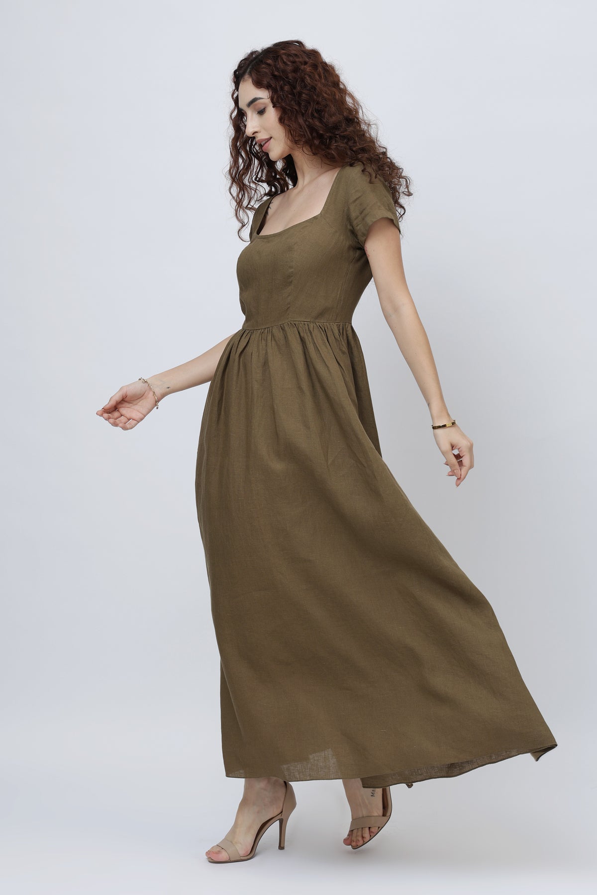 Beautiful woman wearing a long olive brown linen maxi dress