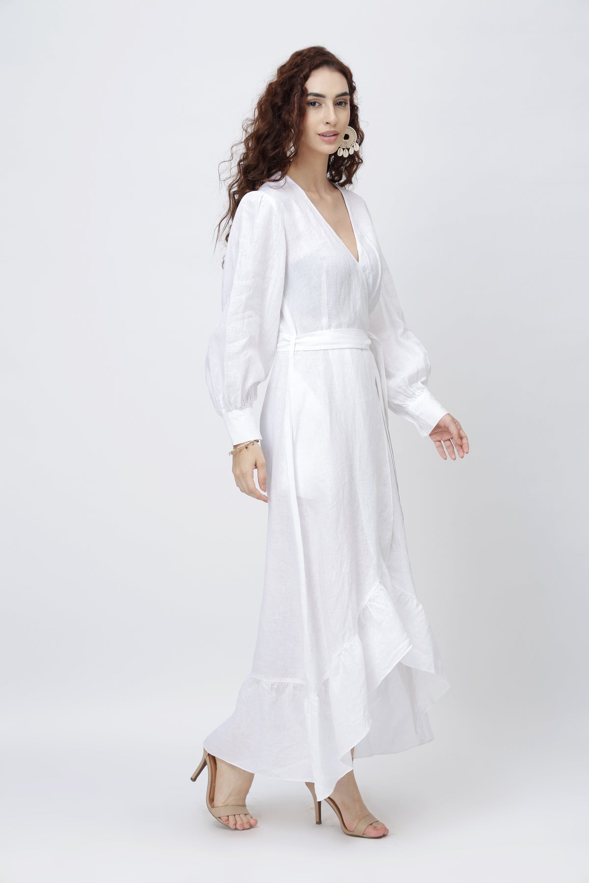 Woman wearing a white linen wrap outfit - side view