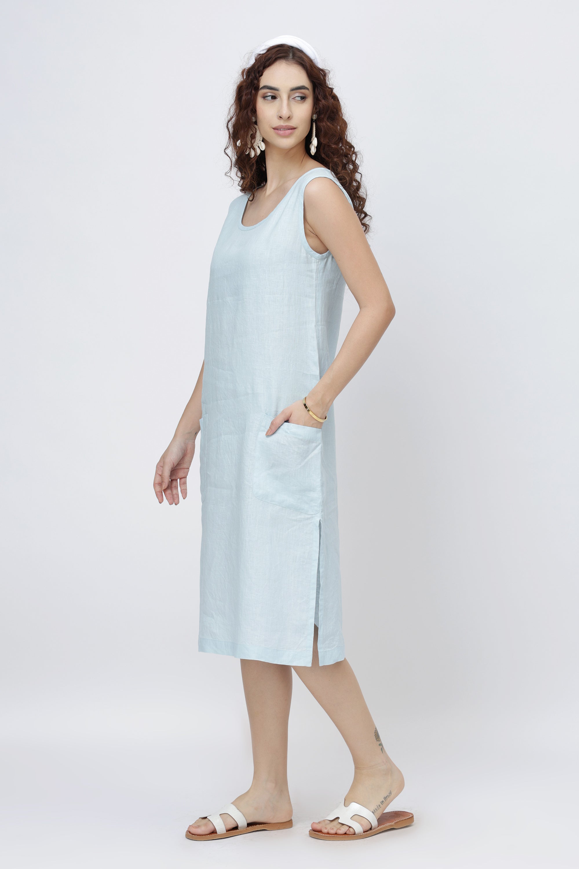 Woman wearing an ice blue sleeveless linen midi dress