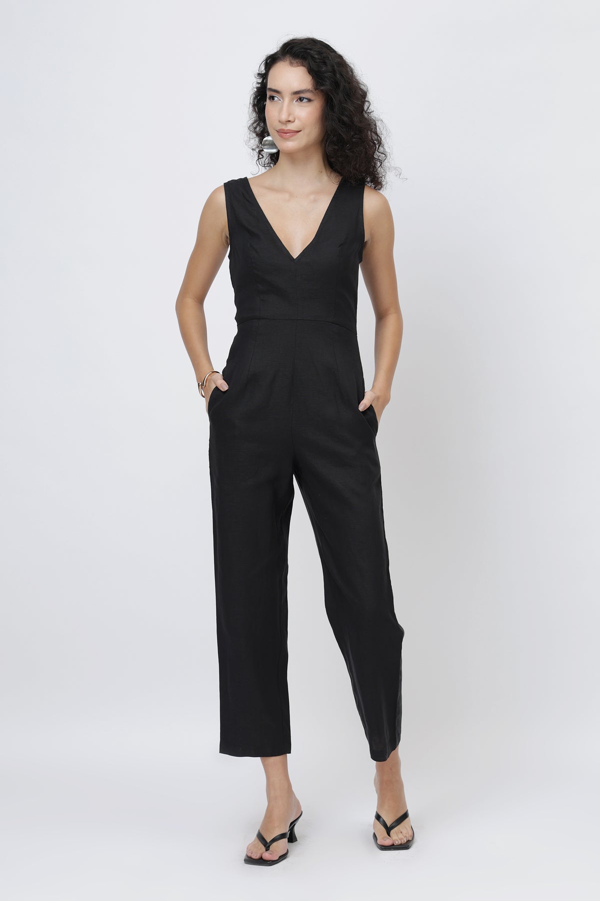 Young woman wearing a sleeveless black jumpsuit