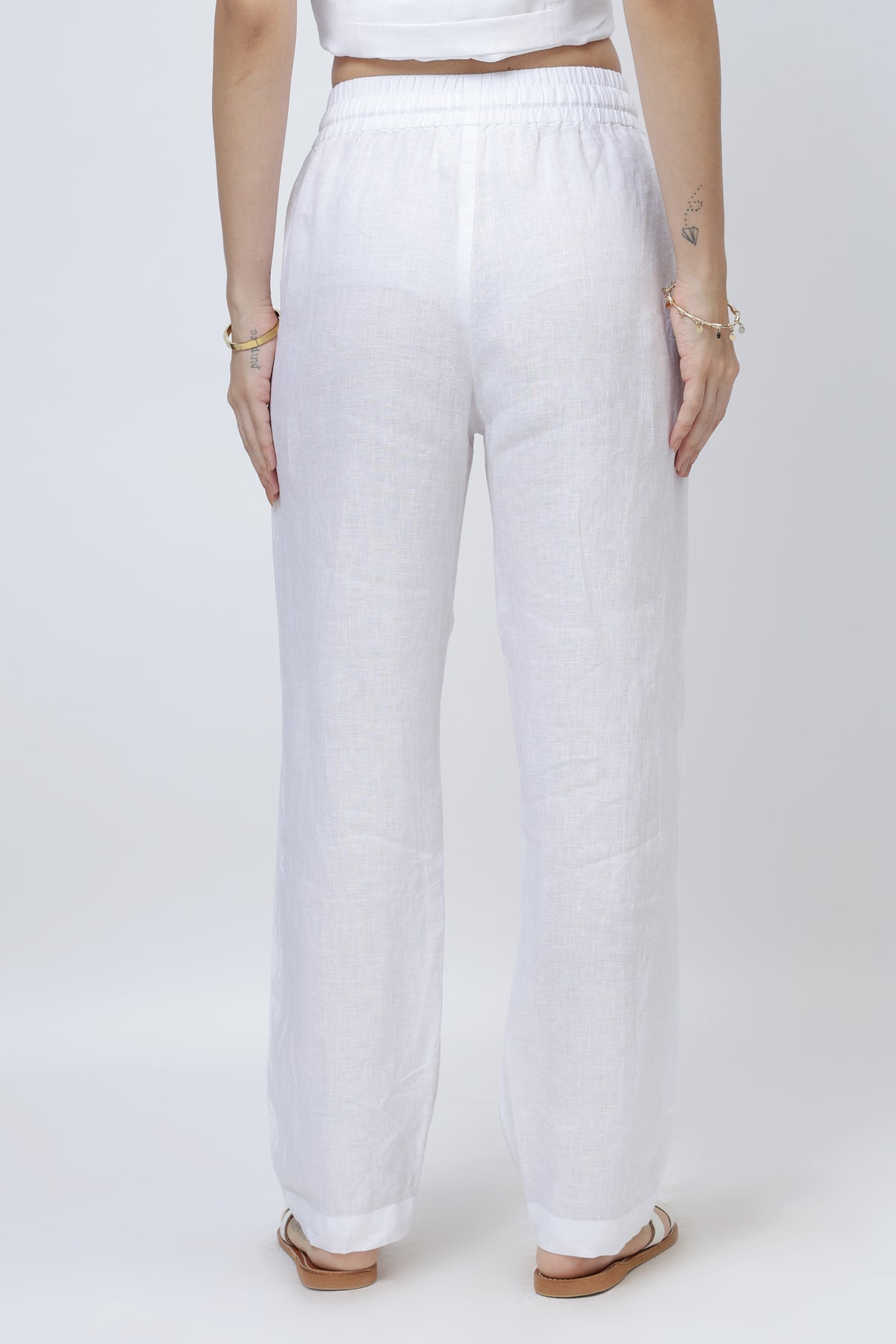 Back view of relaxed linen pants with elastic waistband and clean straight silhouette