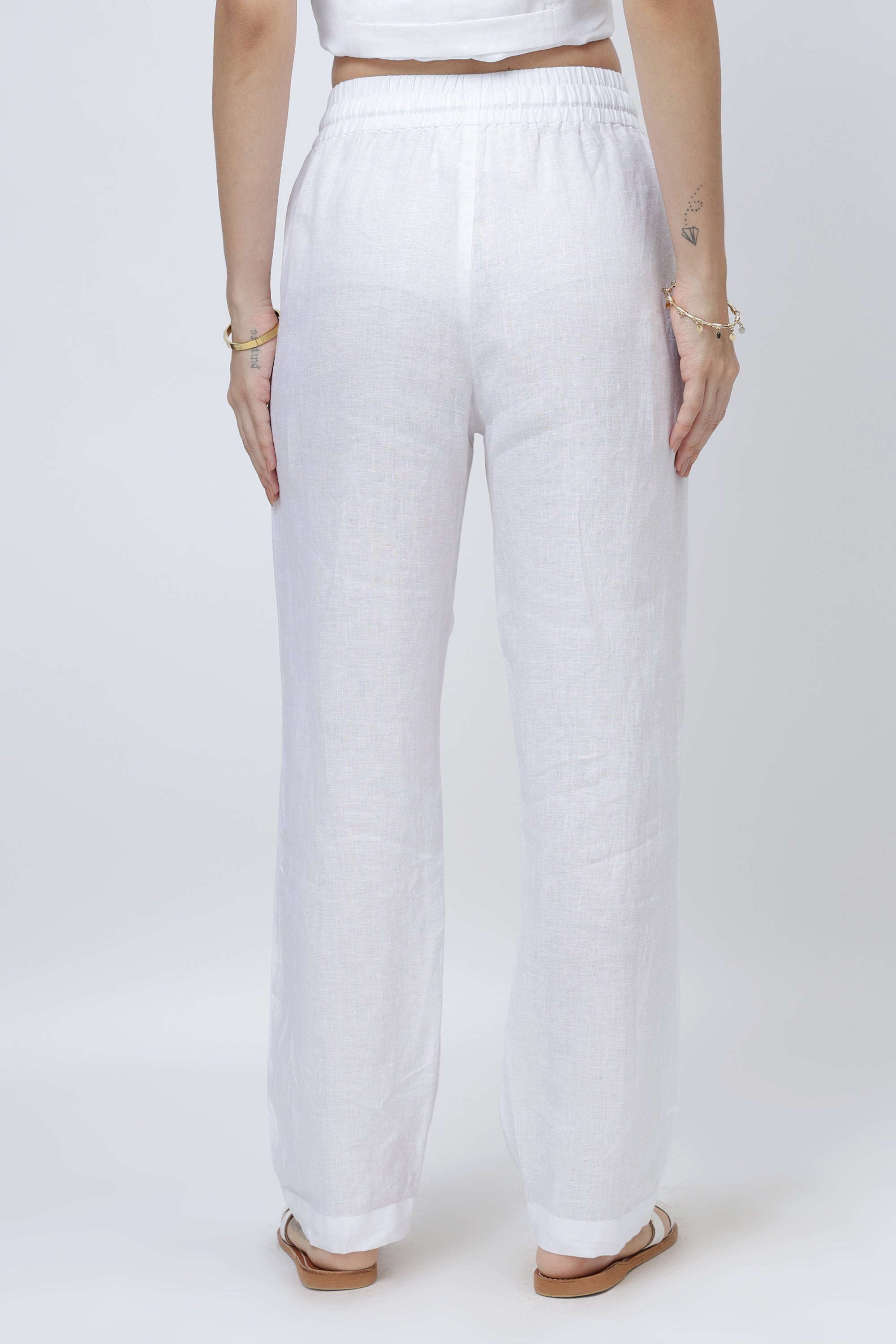 Back view of relaxed linen pants with elastic waistband and clean straight silhouette