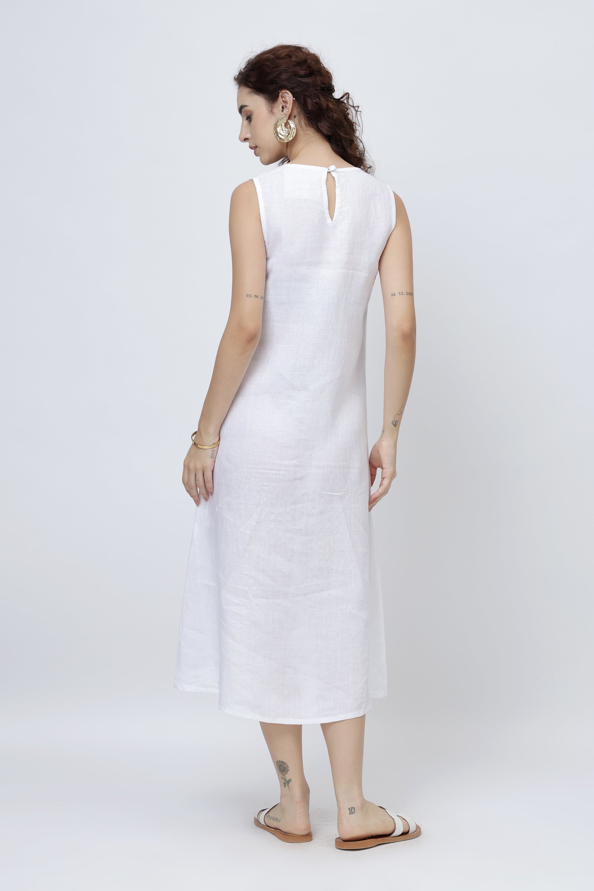 Woman wearing a white sleeveless dress on a white background