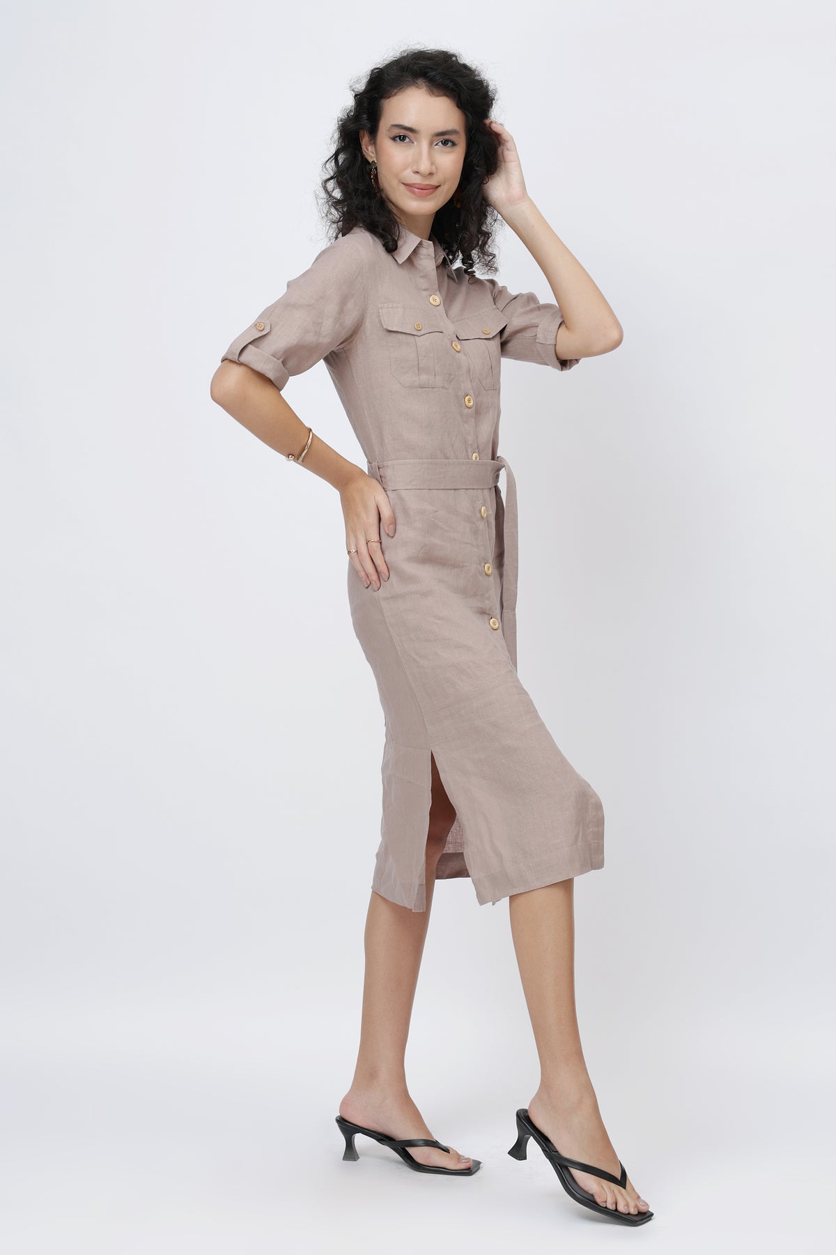 Woman wearing a beige linen shirt dress