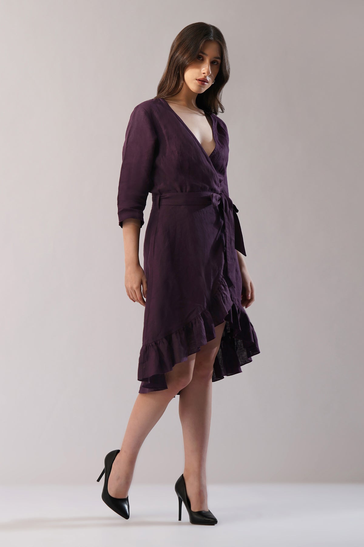 Woman wearing a purple lien wrap dress