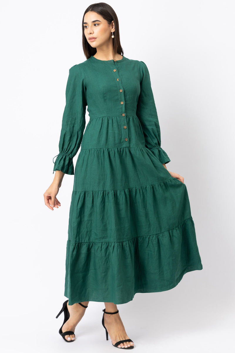 Woman wearing a green linen dress with tiered layers