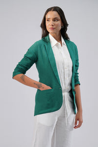 Women wearing green linen blazer with white outfit