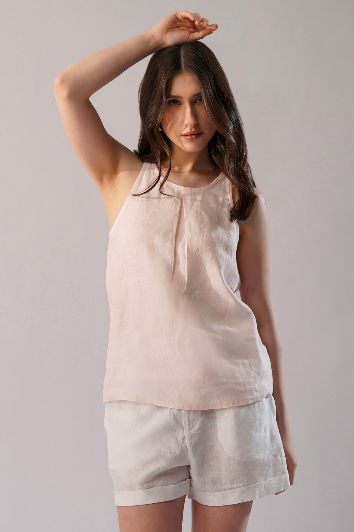 Blush linen sleeveless top with high neckline front view