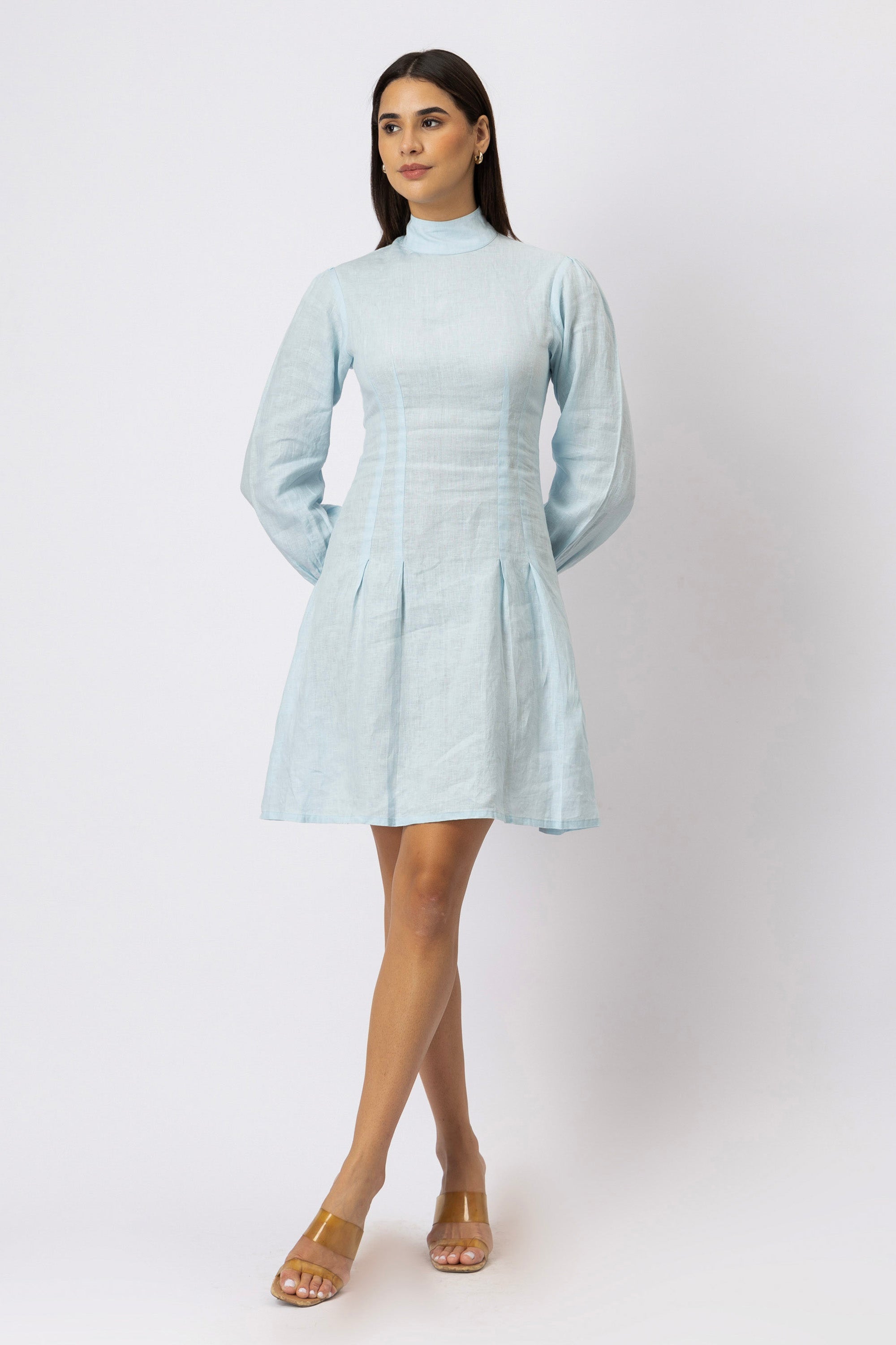 Front view of an ice blue European linen mock neck mini dress with long bishop sleeves