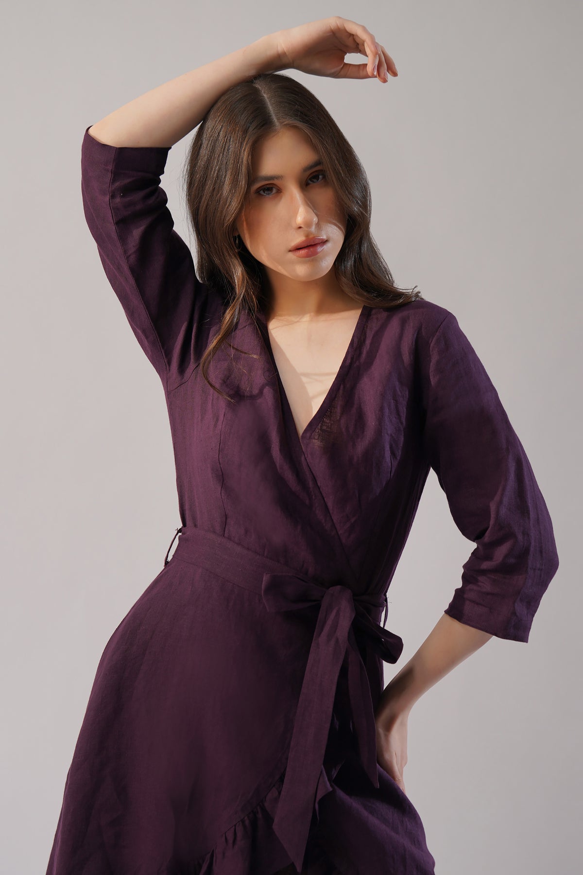 close up of plum linen wrap dress v neckline and waist tie detail