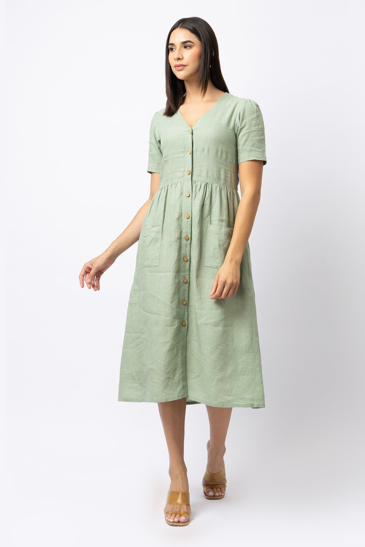 Sage green linen midi dress with short sleeves, gathered waist and wooden buttons
