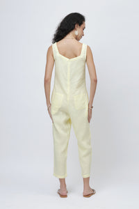 Woman wearing a light yellow linen jumpsuit