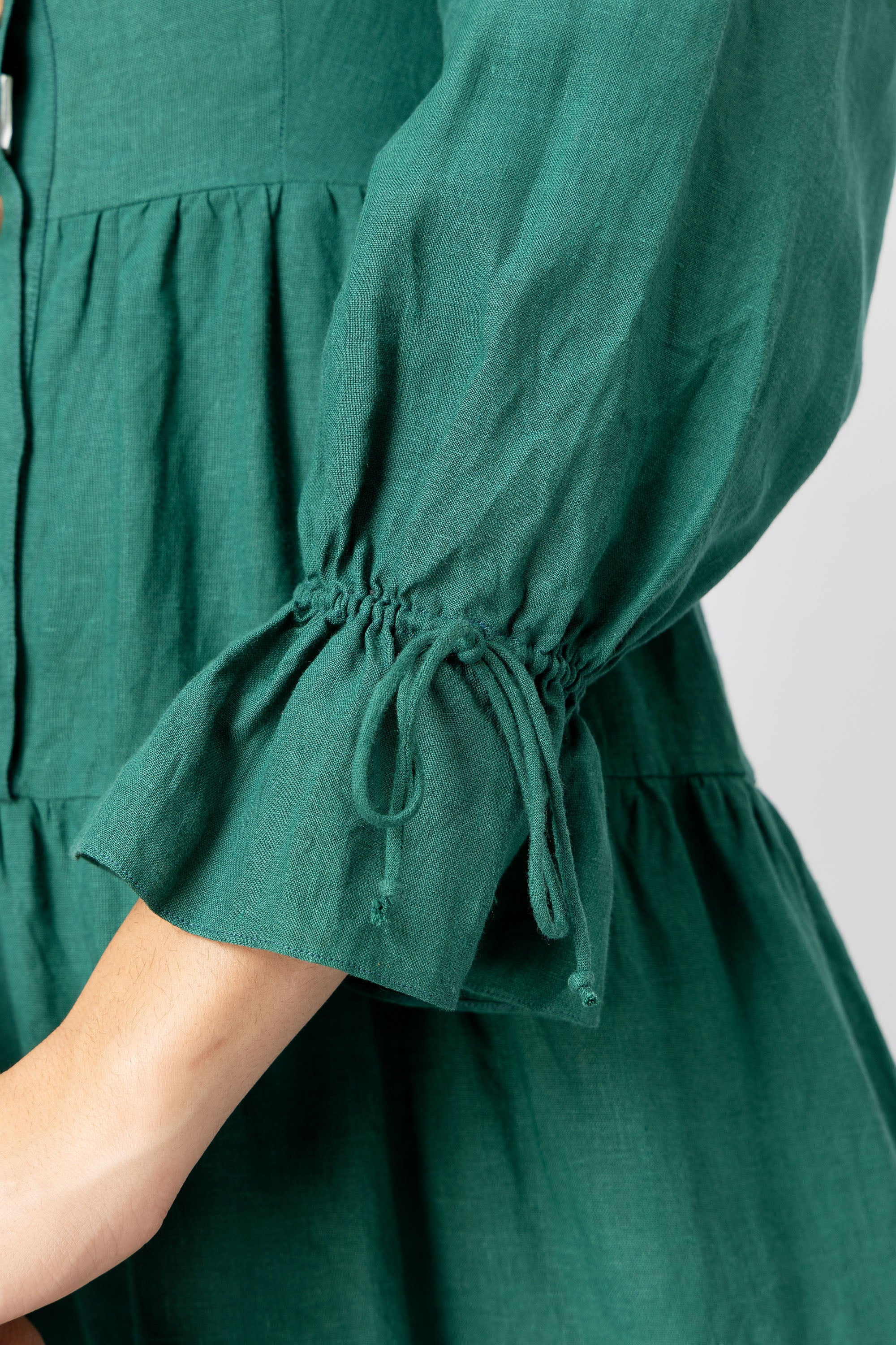 Gathered long sleeve with adjustable tie cuff on green linen maxi dress