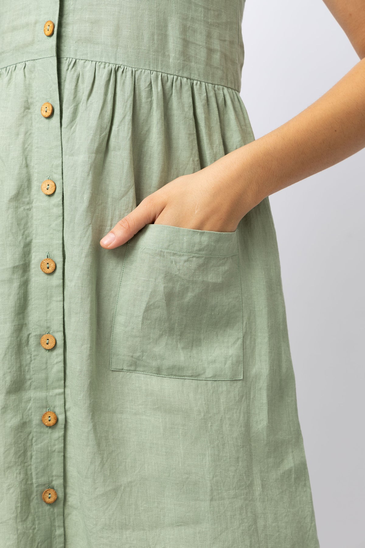Front patch pocket detail on sage green pure European linen midi dress