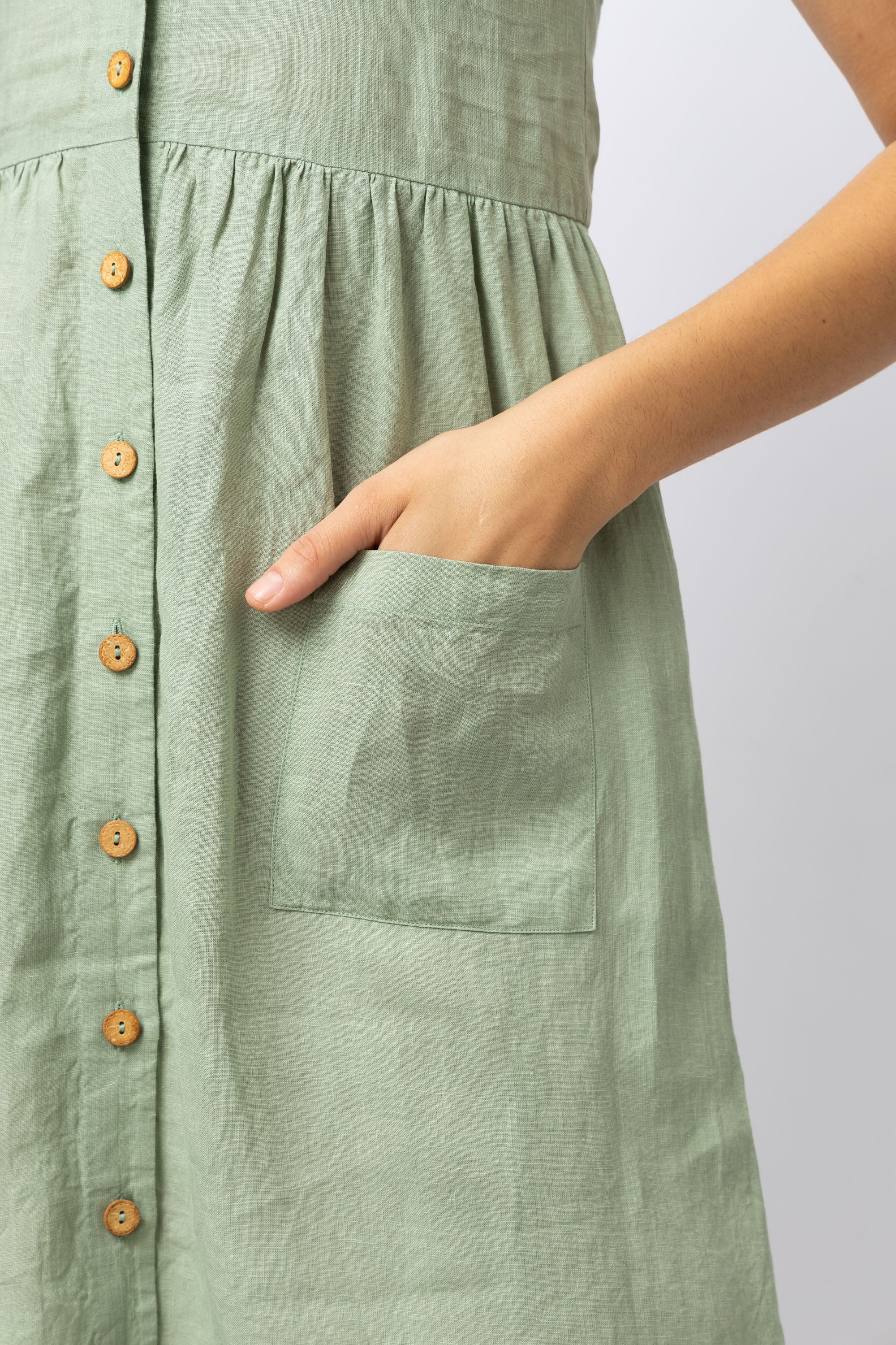 Front patch pocket detail on sage green pure European linen midi dress