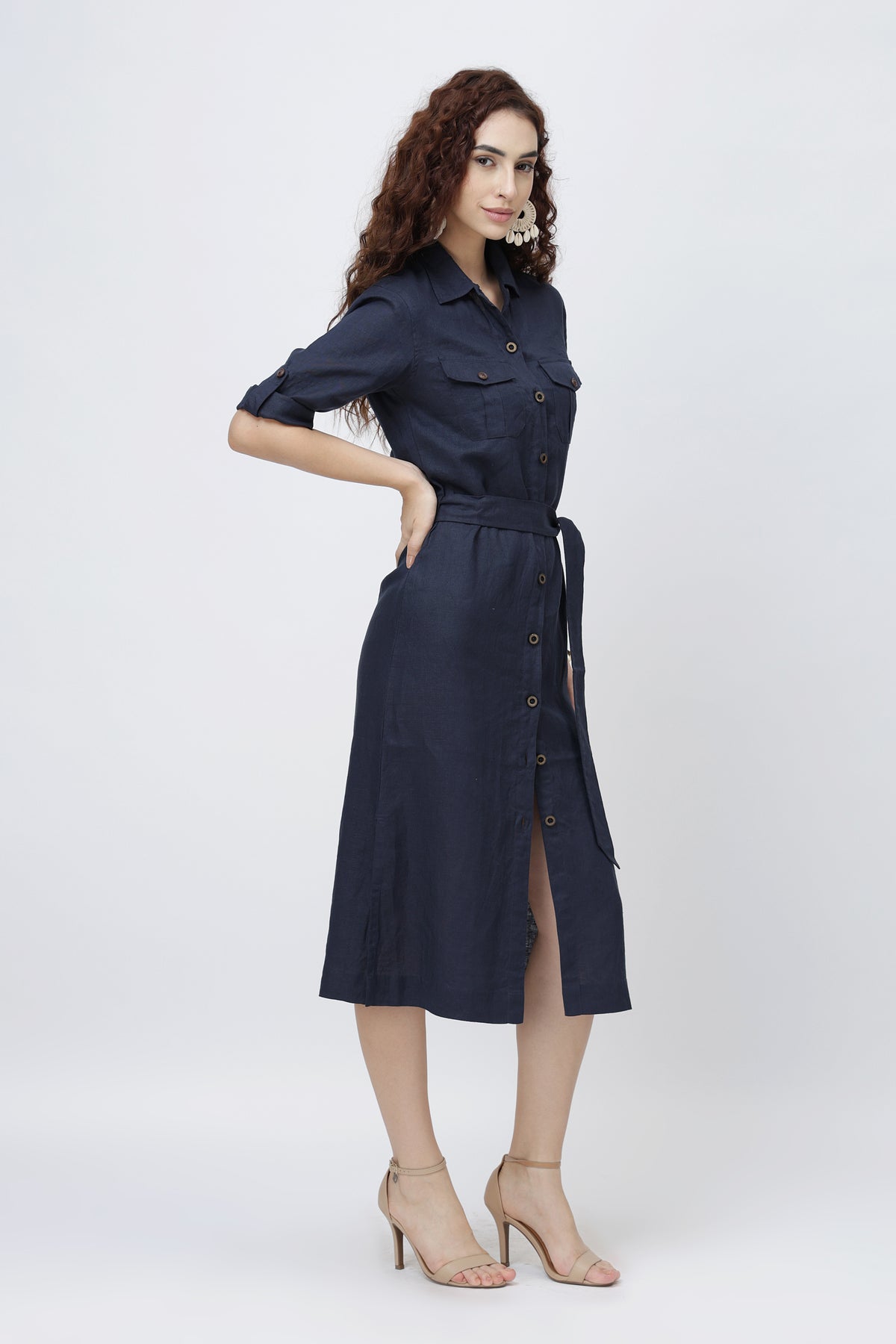 Woman wearing navy blue linen shirt dress with a belt