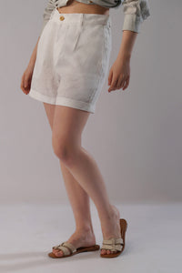lady wearing optic white linen shorts