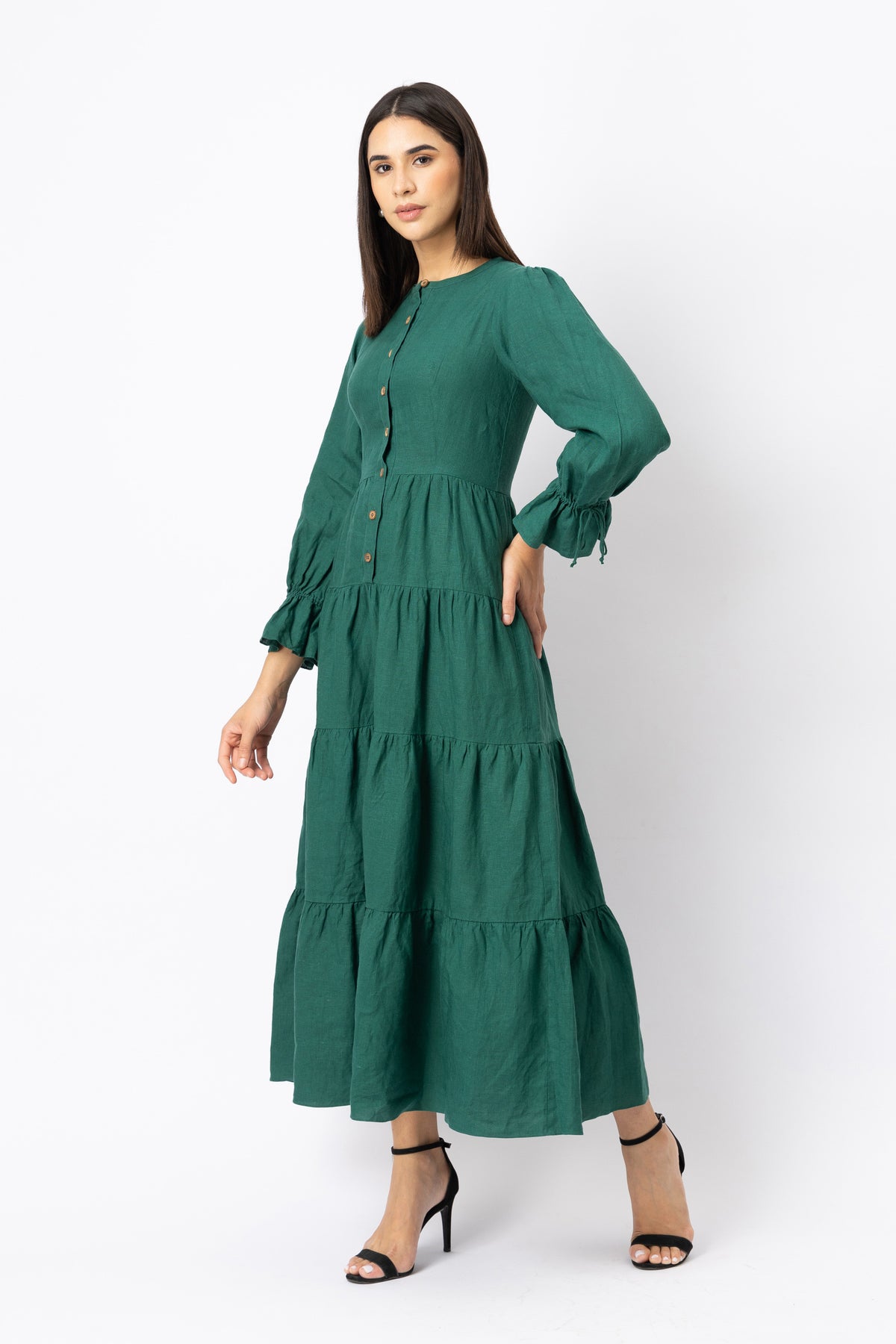 Defined waist seam on green linen button-front tiered maxi dress