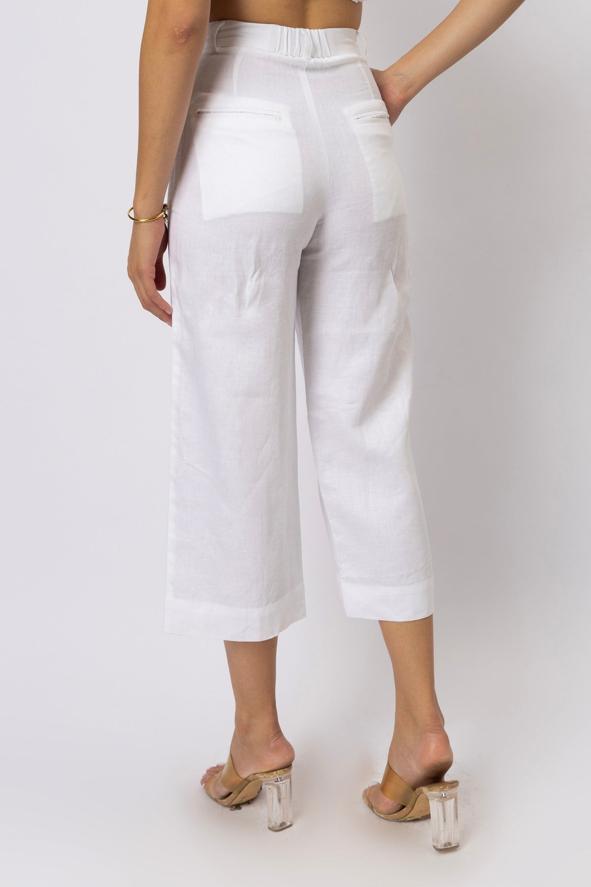 Relaxed straight-leg capri pants shown from the rear three-quarter view