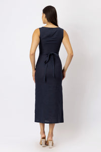 Back view of a European linen midi dress with a fitted waist and adjustable tie-back detail