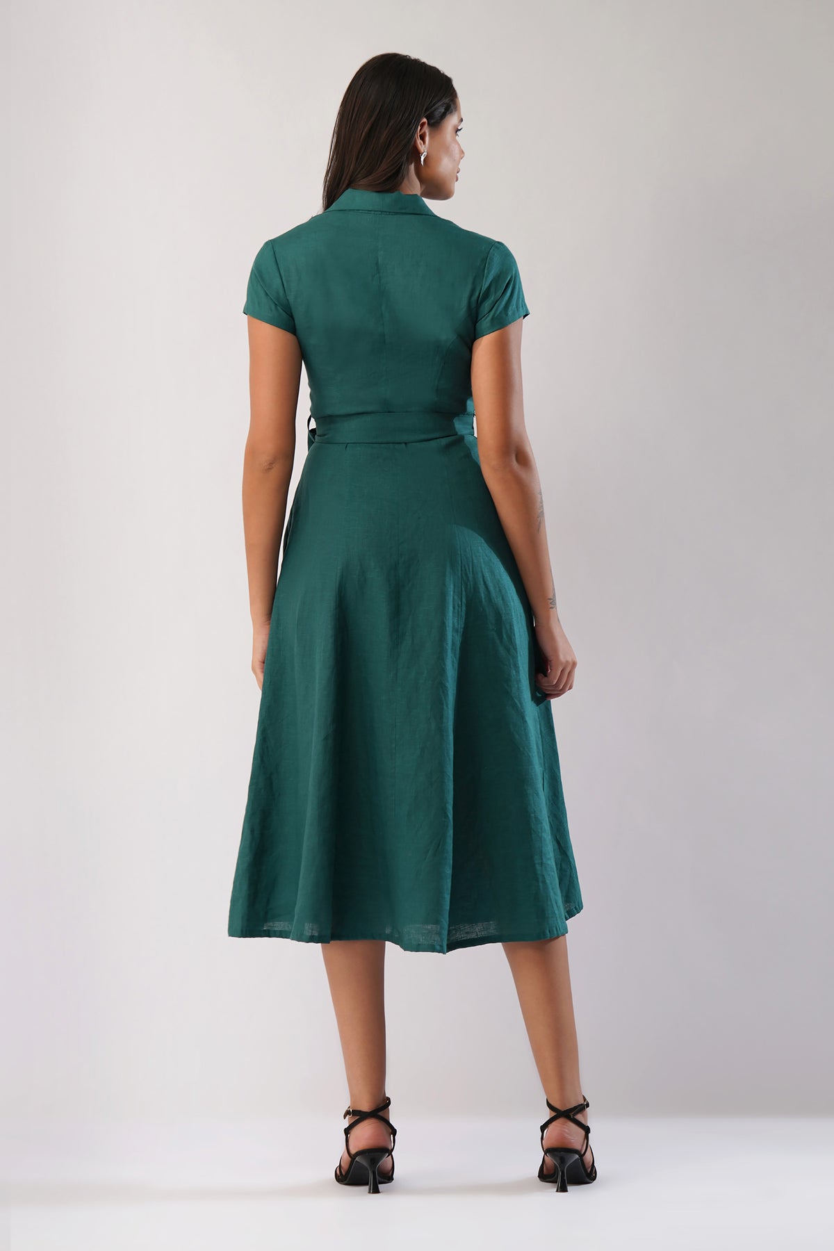 Back view of a linen midi dress with short sleeves, waist tie and flared A-line skirt
