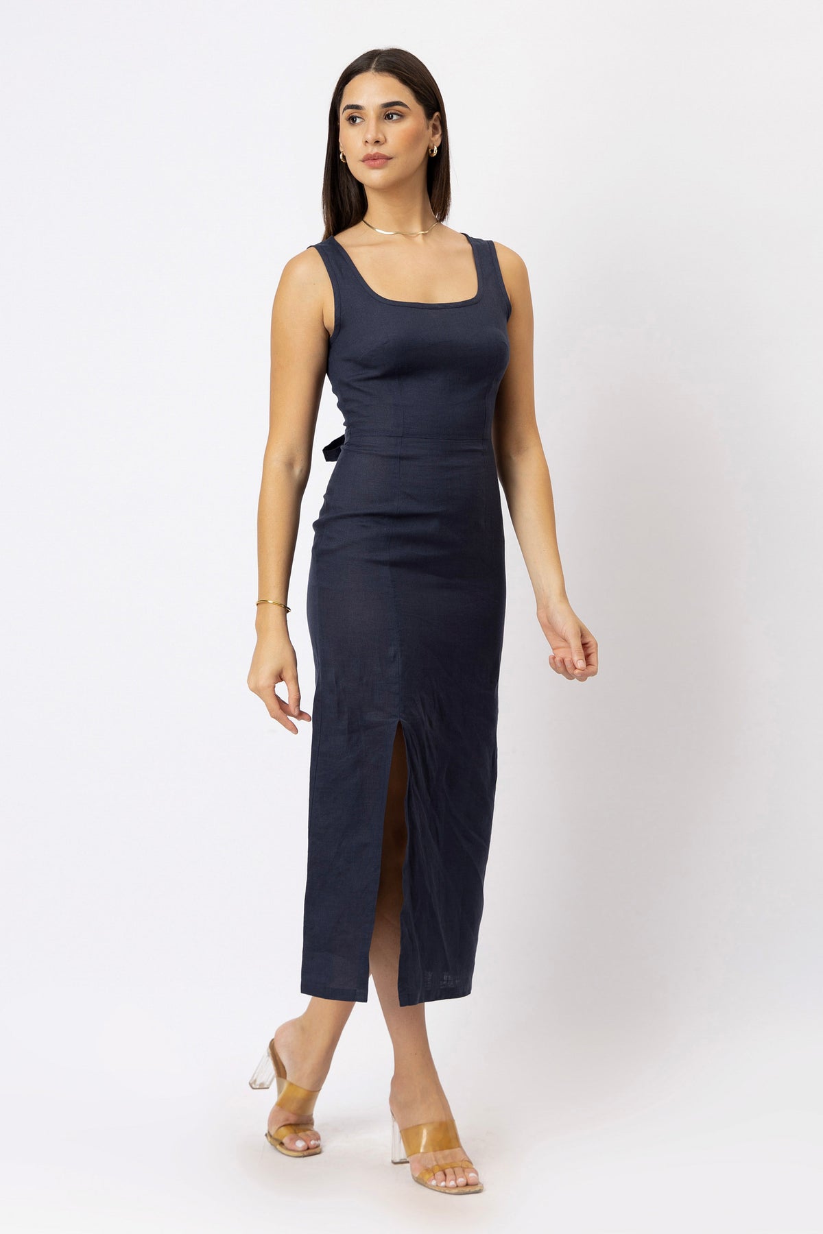 Model wearing a linen midi dress with a square neckline, fitted waist, and front side slit