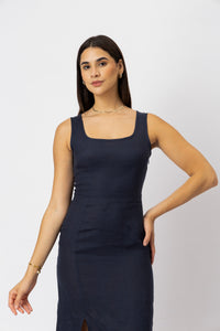 linen midi dress with a structured square neckline and fitted waist, close-up view