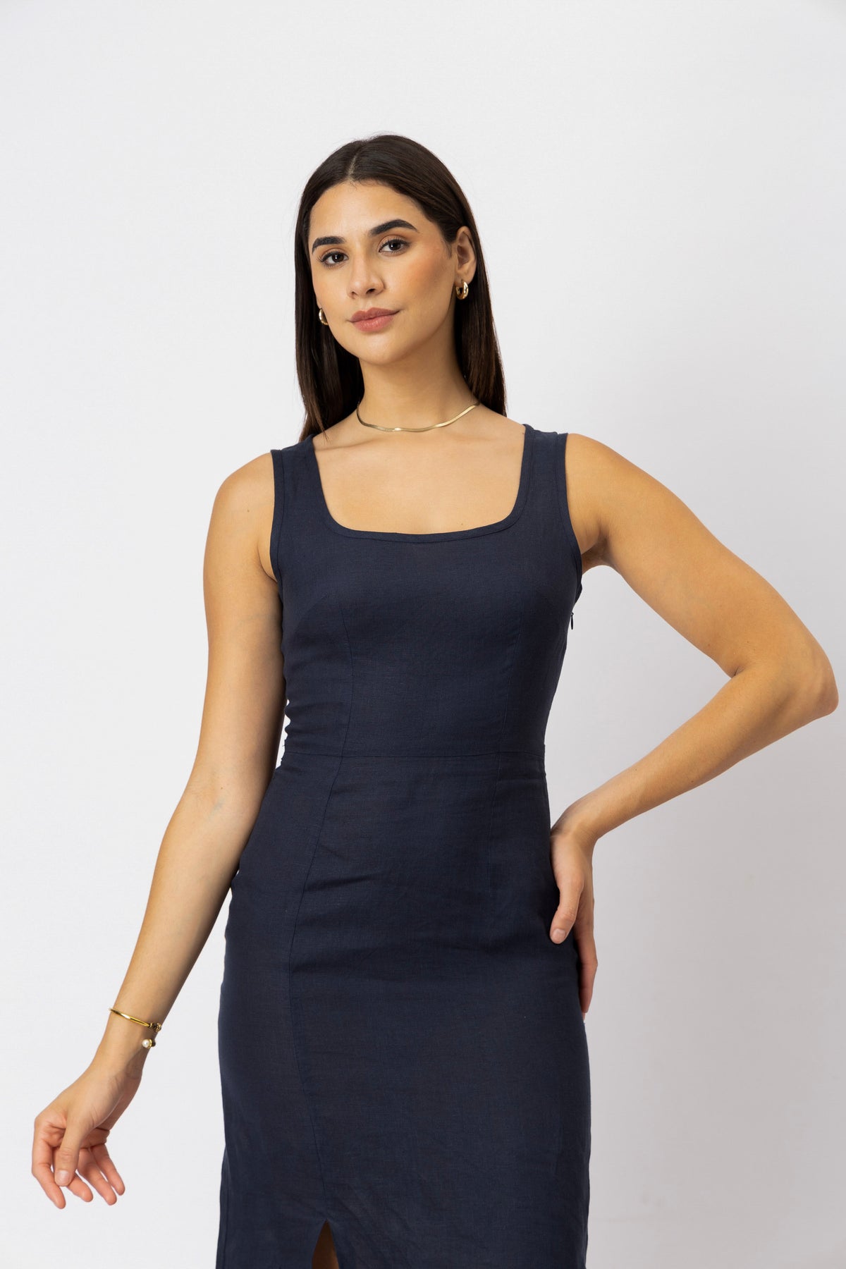 linen midi dress with a structured square neckline and fitted waist, close-up view