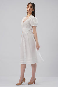 European linen V-neck midi dress with puff sleeves, button placket, defined waist and pleated skirt, three-quarter view