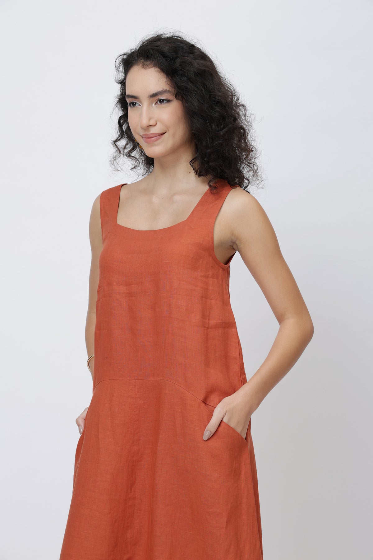 Woman wearing a rust-colored linen dress