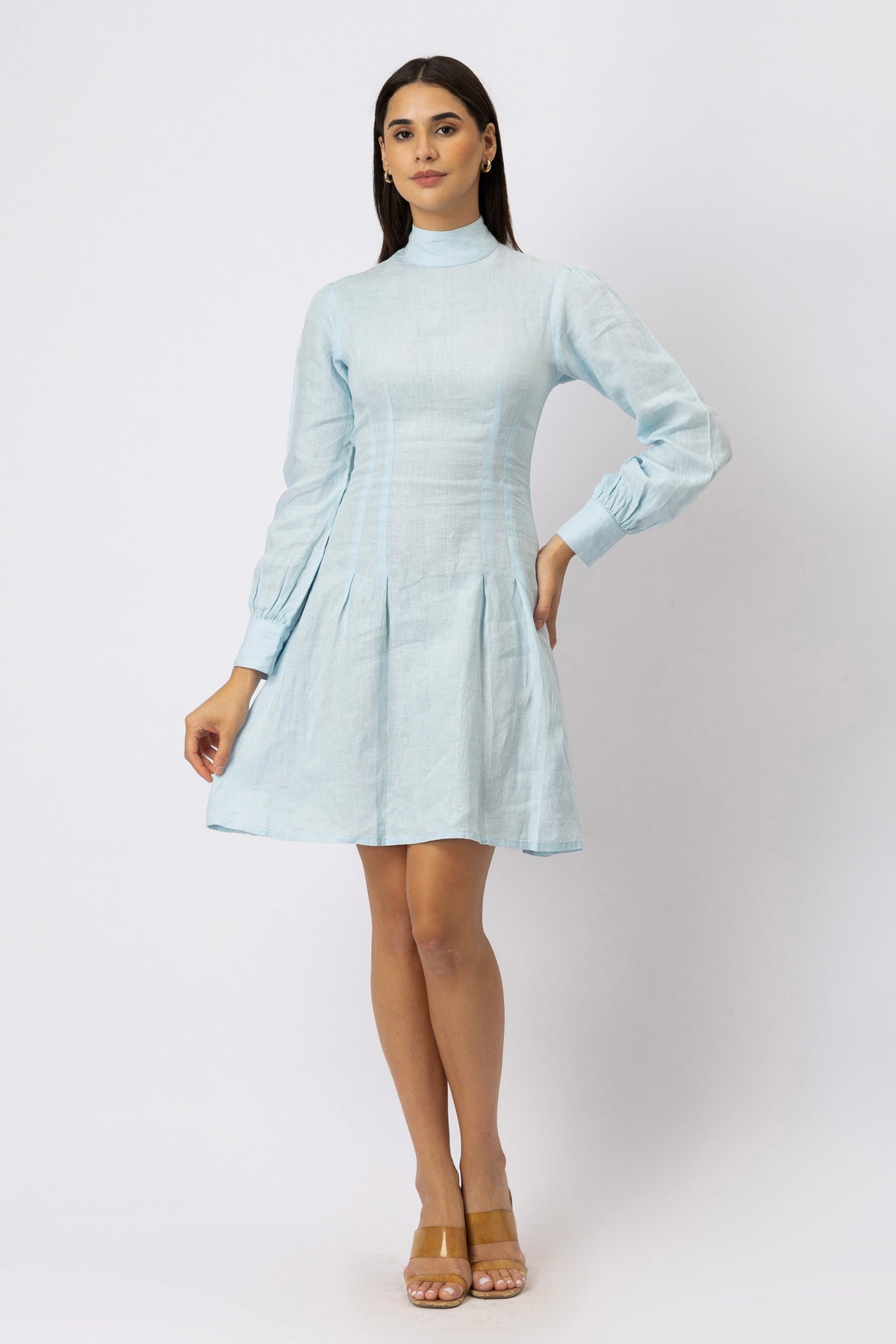 Model wearing the Kuttons mock neck pleated linen mini dress in ice blue