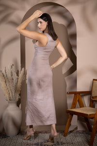 Woman wearing a linen fitted midi dress, shown from the back in a warm minimalist interio