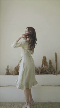 female fashion model wearing natural linen wrap dress with frills