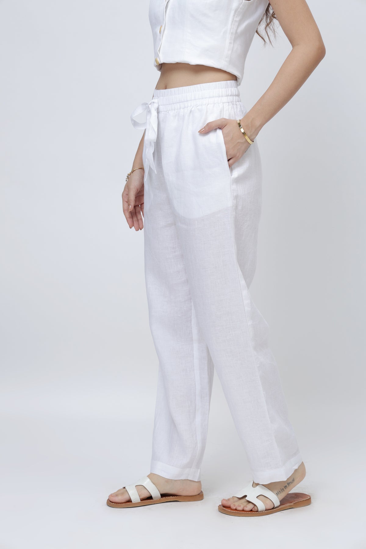 Side view of white linen pants for women showing relaxed fit and breathable fabric
