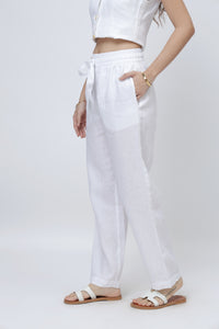 Side view of white linen pants for women showing relaxed fit and breathable fabric
