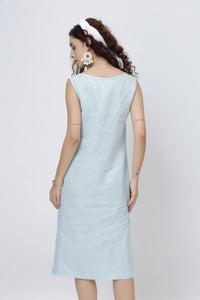 Woman wearing a light blue european linen midi dress 