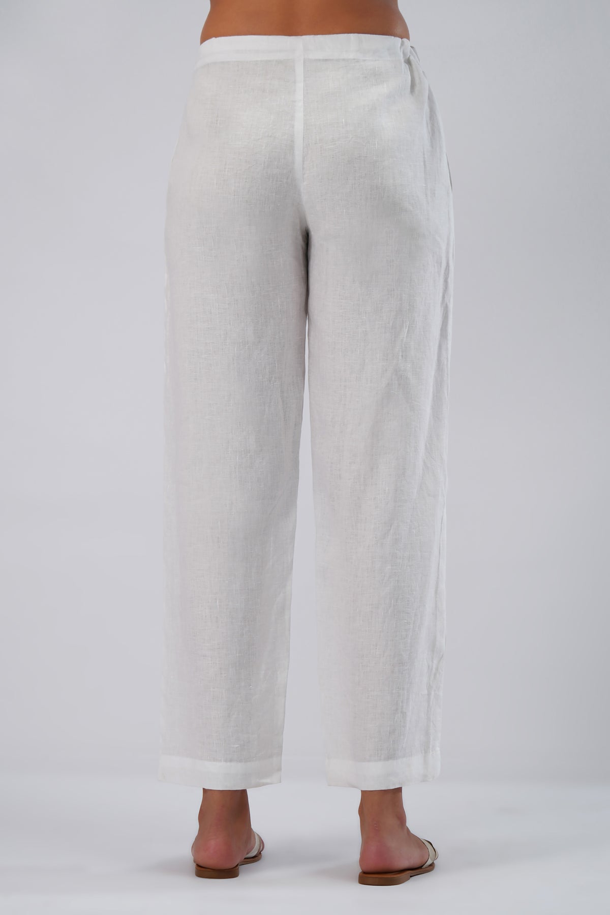 back view of white european linen pants with adjustable tie waist