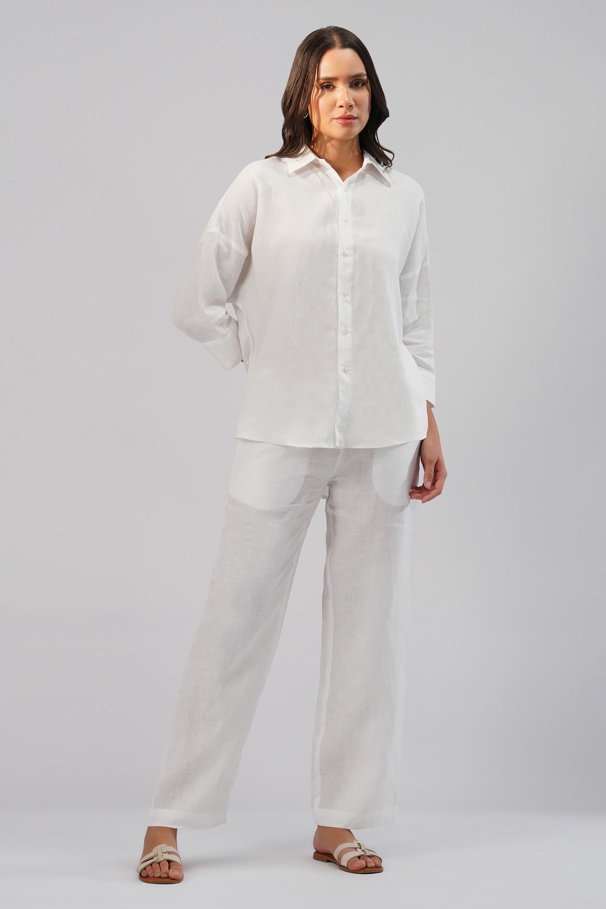 Woman wearing a white European linen shirt and pants