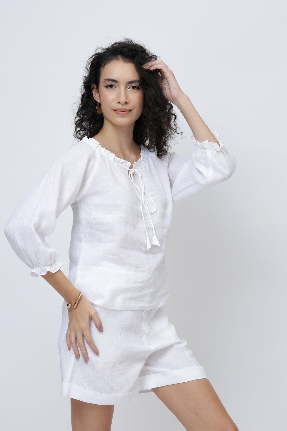 Woman wearing a white linen outfit 