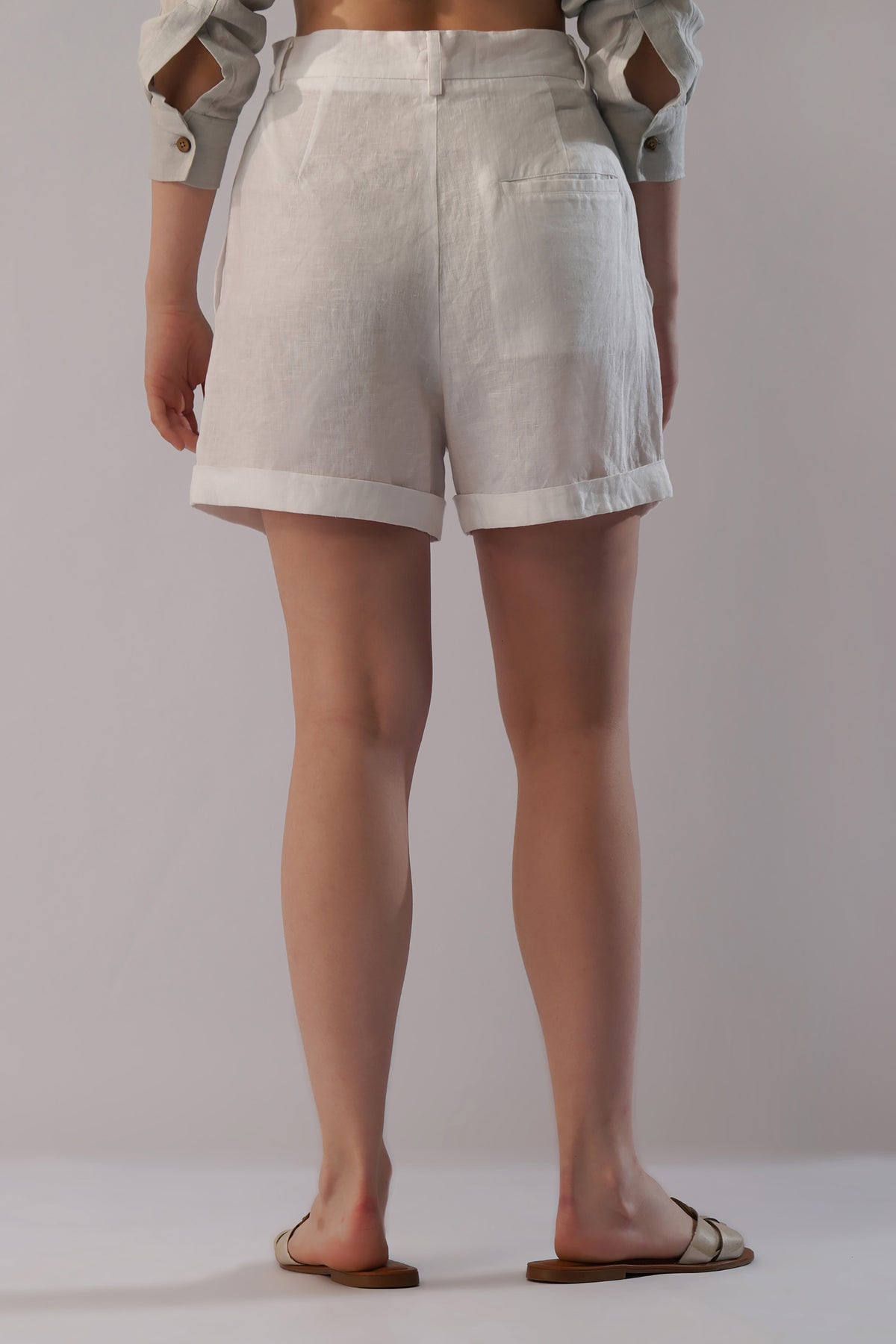 Back view of women’s linen shorts with elastic-free waistband and single welt pocket