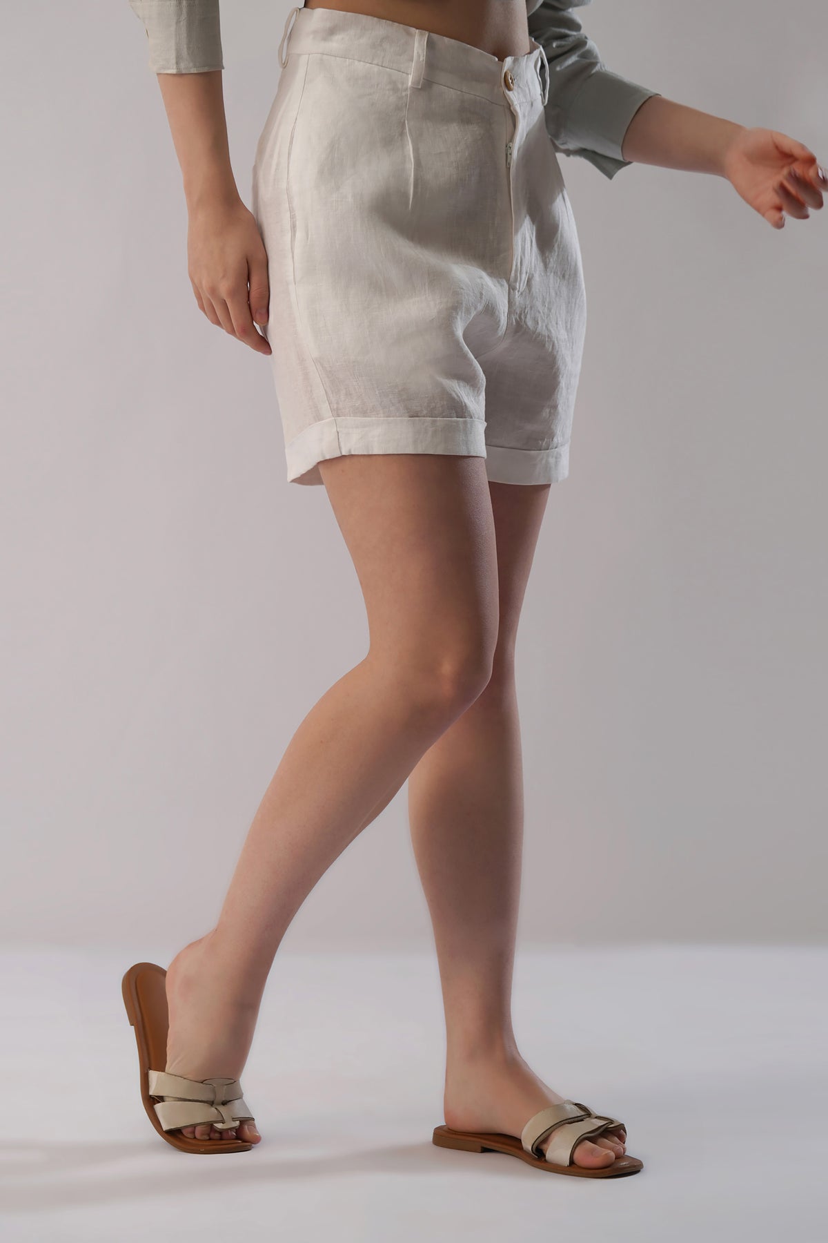 Side view of women’s linen shorts showing relaxed tailored fit and cuffed hem detail