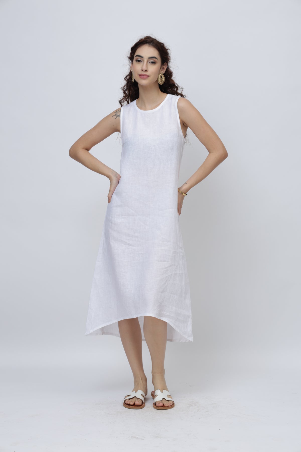 Woman wearing a optic white sleeveless linen midi dress